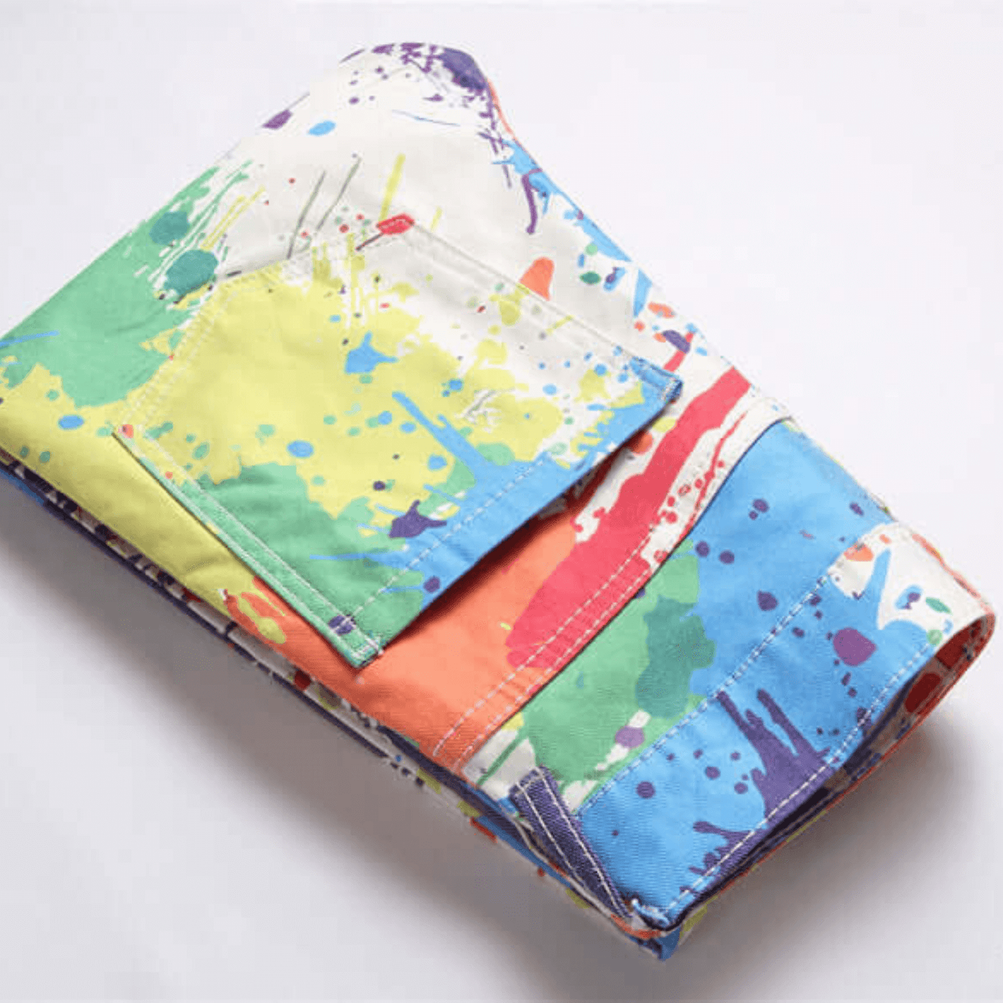 Men's slim-fit paint splatter jeans in multi-color denim, featuring a relaxed fit and premium quality.