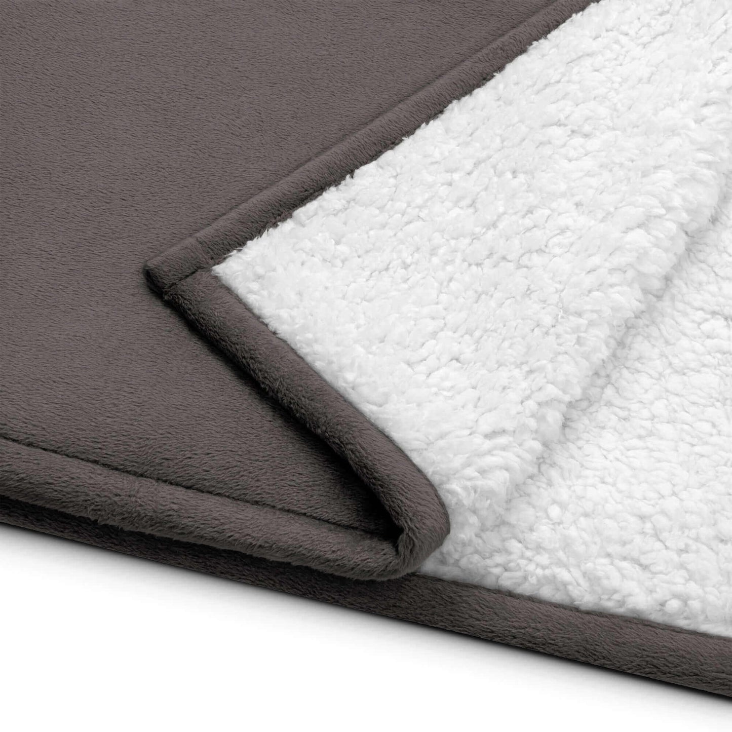 Close-up of YB Goode Signature Embroidered Sherpa Blanket showcasing the warm fleece and plush sherpa sides.