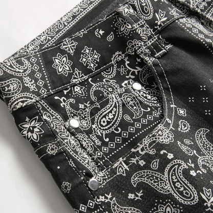 Men's relaxed-fit paisley print denim jeans displaying intricate patterns and premium quality fabric.