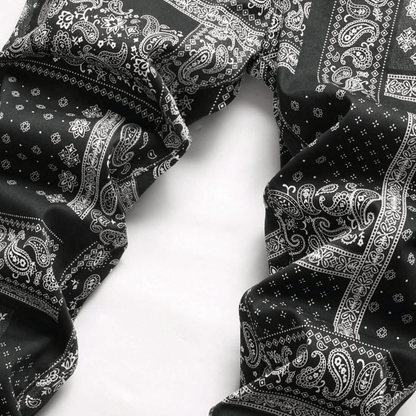 Men's relaxed-fit paisley print jeans in black and white, showcasing premium quality denim and retro urban style.