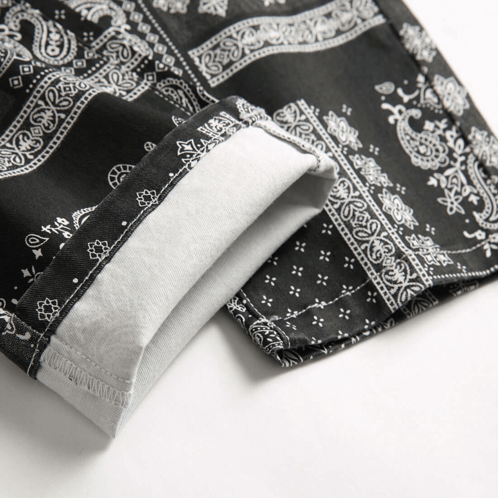 Close-up of relaxed-fit paisley print jeans showing cuff detail in premium quality denim for retro urban style.