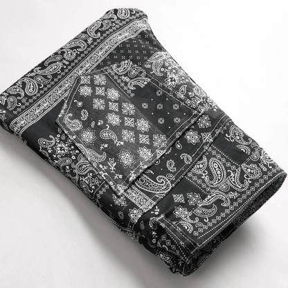 Men's relaxed-fit paisley print jeans in premium black denim, showcasing retro urban style and comfort.