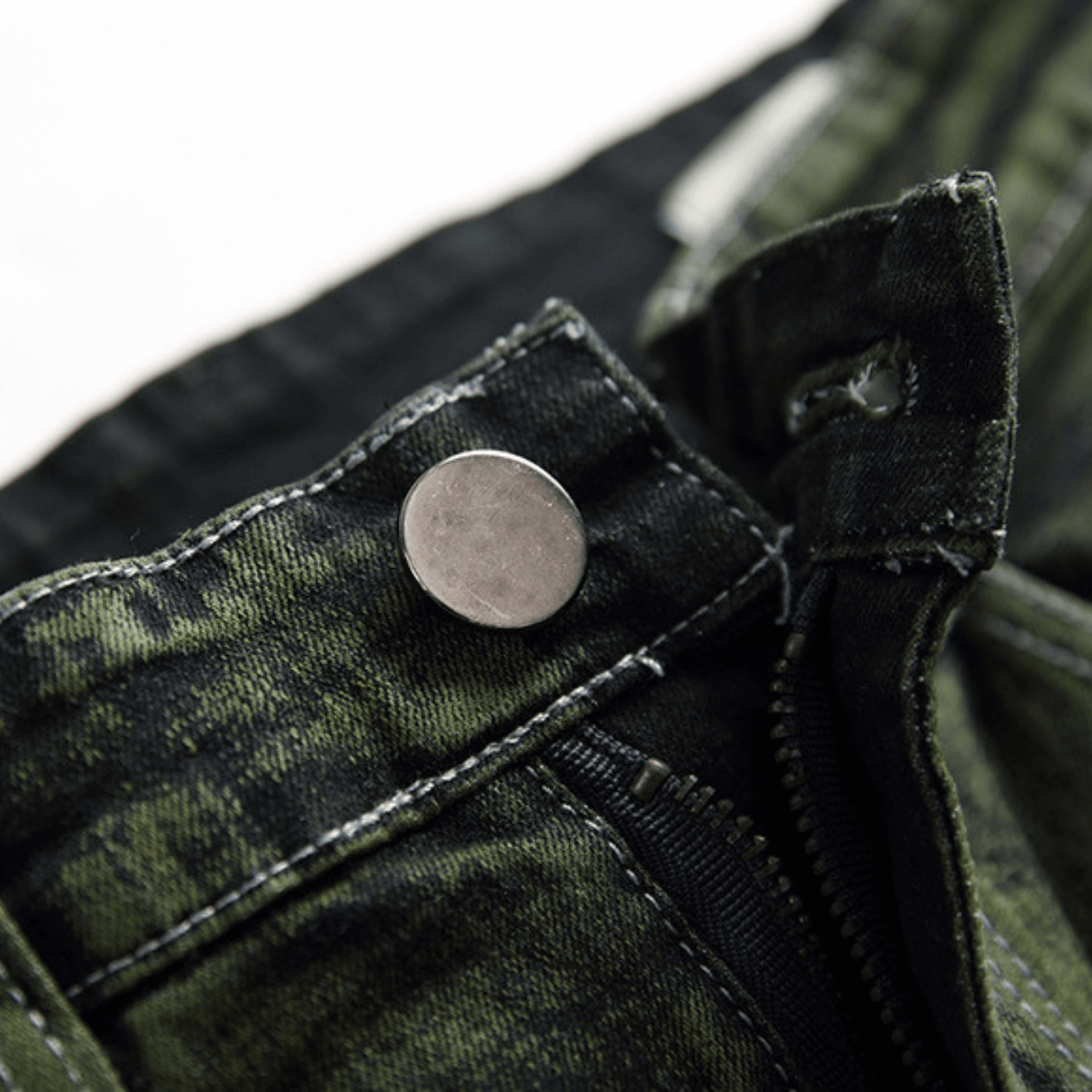Close-up of the button detail on men's slim-fit green faded designer denim jeans, showcasing premium quality fabric.