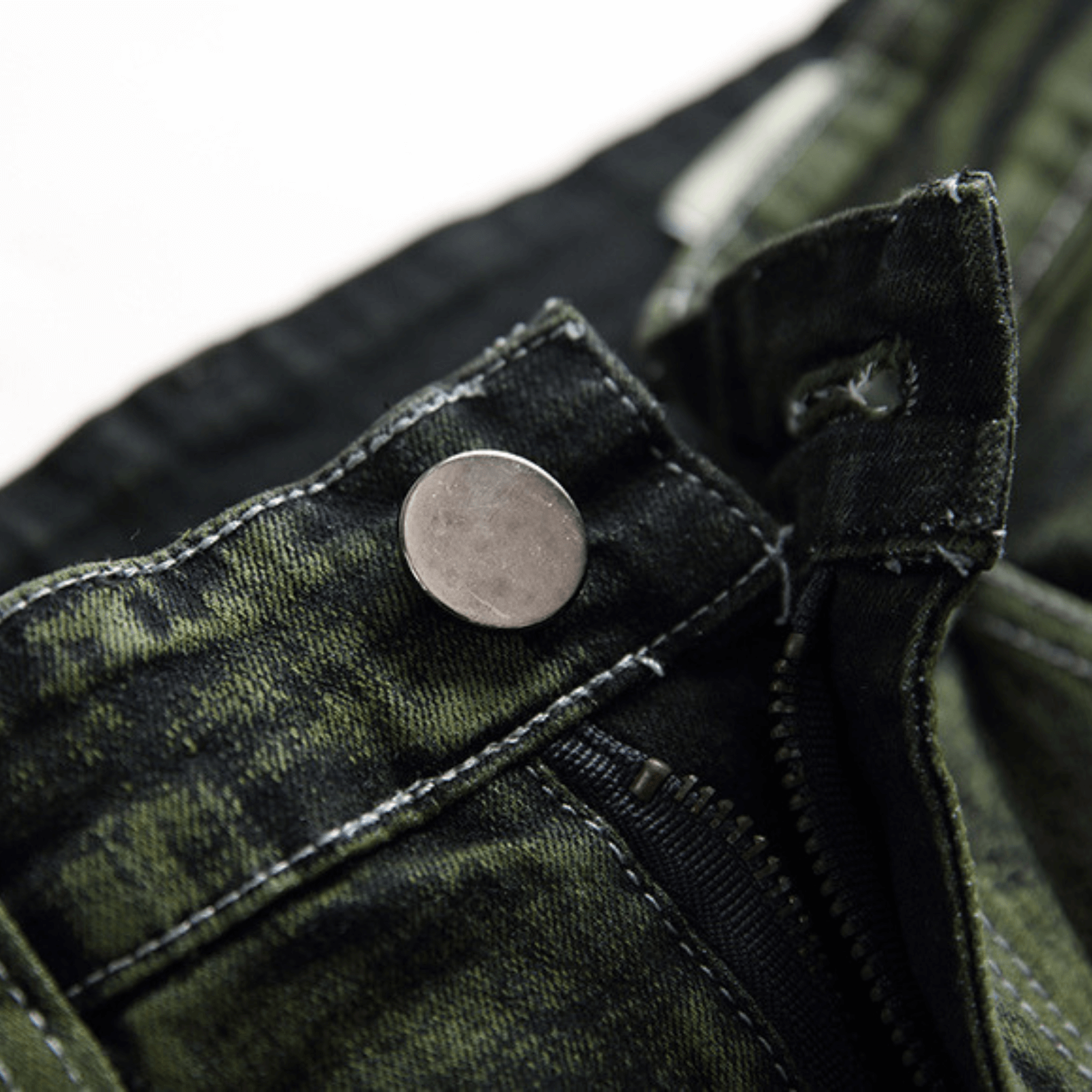 Close-up of the button detail on men's slim-fit green faded designer denim jeans, showcasing premium quality fabric.