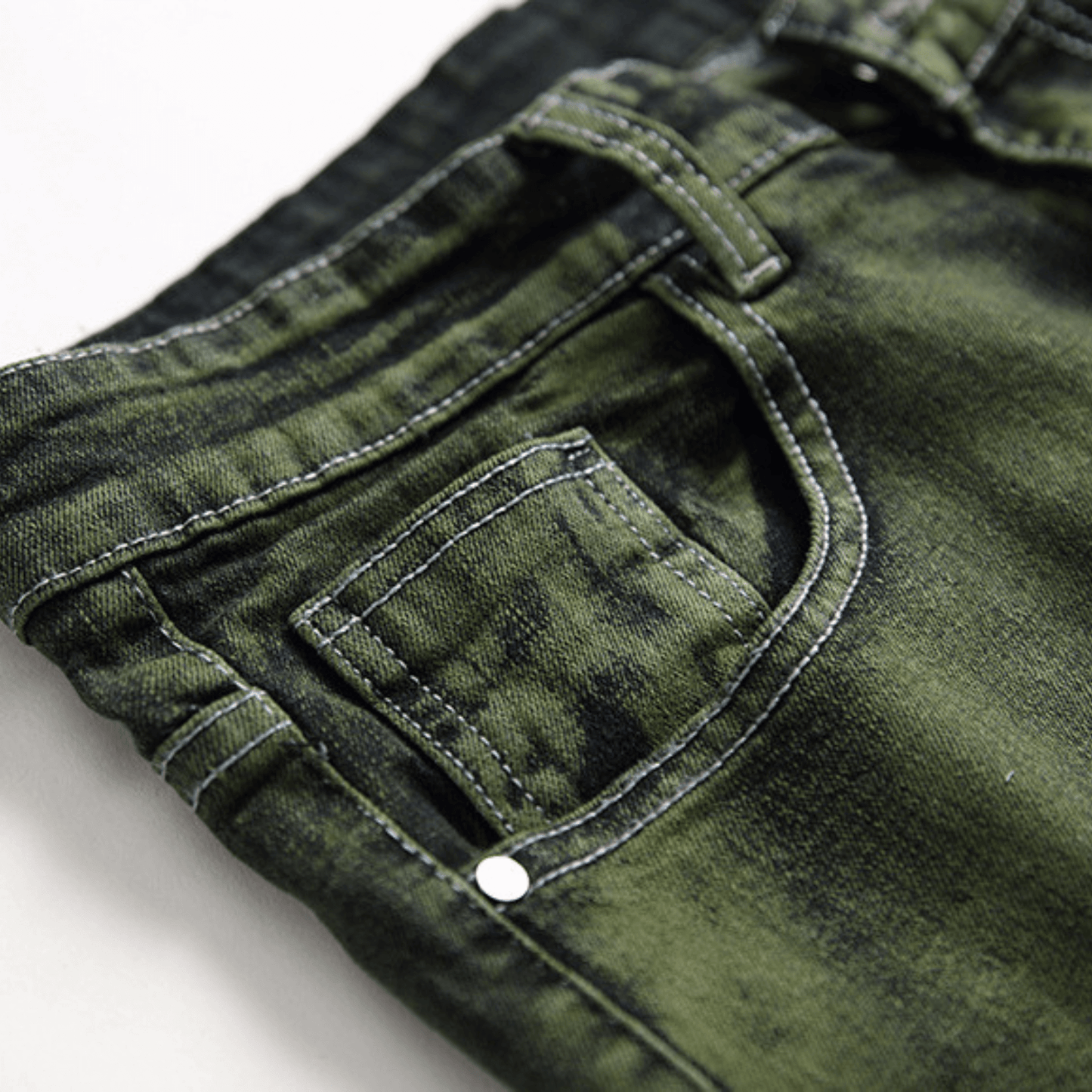 Close-up of men's slim-fit green faded designer denim jeans showcasing premium quality fabric and detailed stitching.